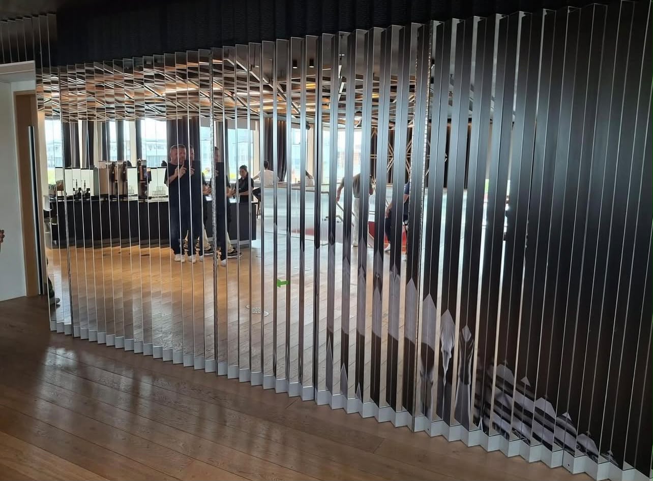 Feature wall of vertical mirrored glass louvres